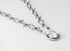 Silver bracelet with a clear gemstone on a white background